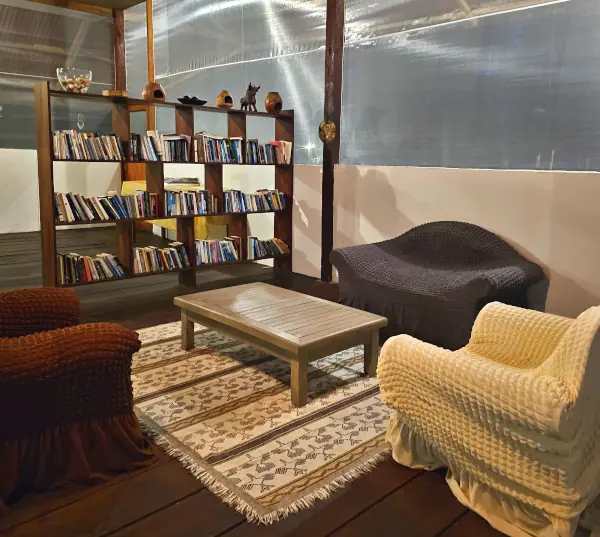 Cozy library lounge with comfortable seating and stocked bookshelves