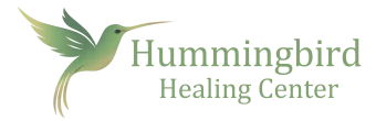 Light green hummingbird illustration next to "Hummingbird Healing Center" in matching green text.