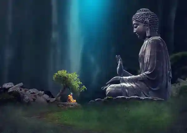 Large Buddha statue and small monk meditating under a tree, bathed in mystical blue light.